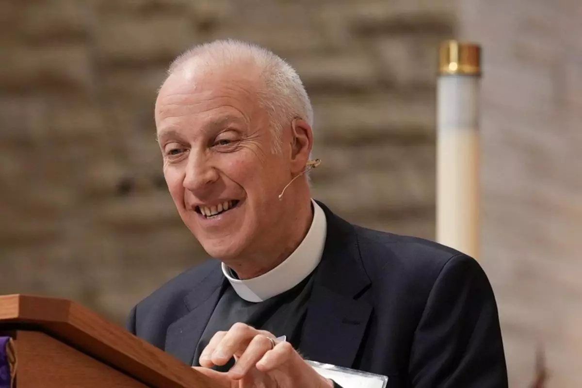 An image of MichaeL Lloyd standing at a lectern preaching